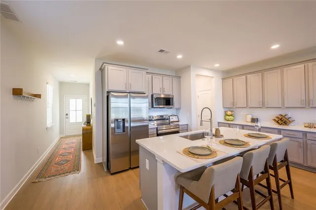 a kitchen with refrigerator and a table