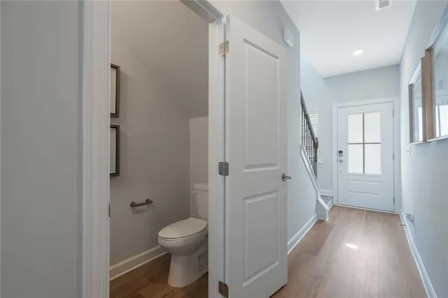 a kitchen with stainless steel appliances wooden floor dining table and chairs