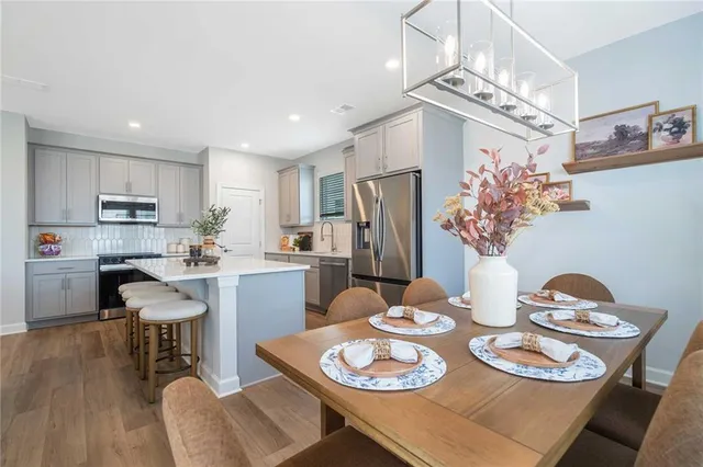 a kitchen with counter space dining table and chairs