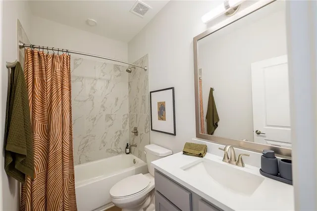 an aerial view of a house with a yard and large trees