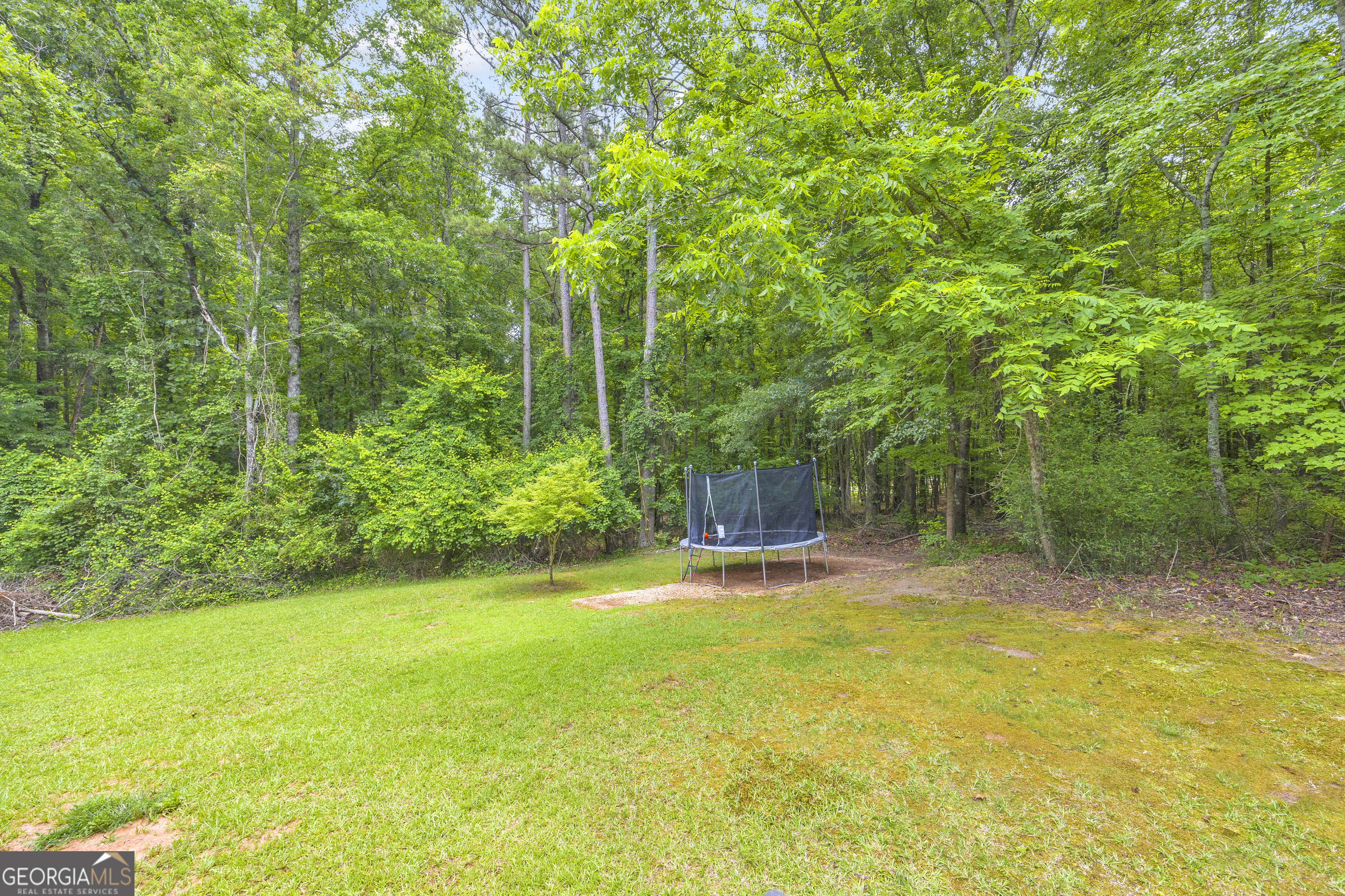 163 Tuxedo Drive Commerce, GA 30530 - Photo 55 of 62 a backyard of a house with table and chairs