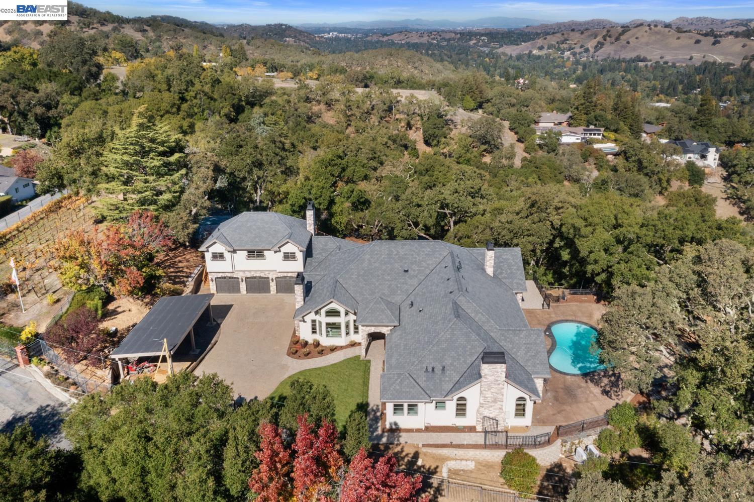 an aerial view of a house with a yard