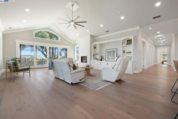 a living room with furniture and a wooden floor