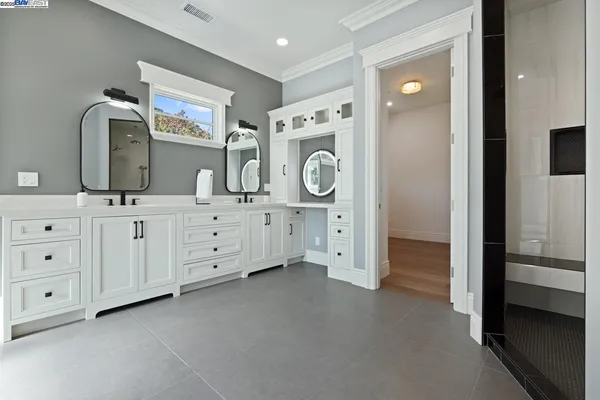 a spacious bathroom with a granite countertop sink and a mirror