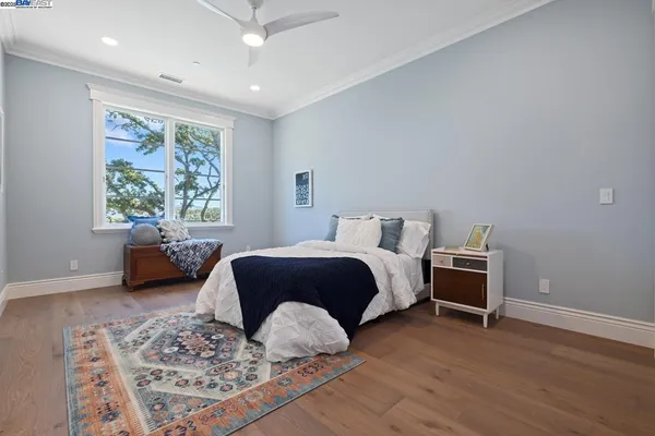 a spacious bedroom with a bed a couch and a window