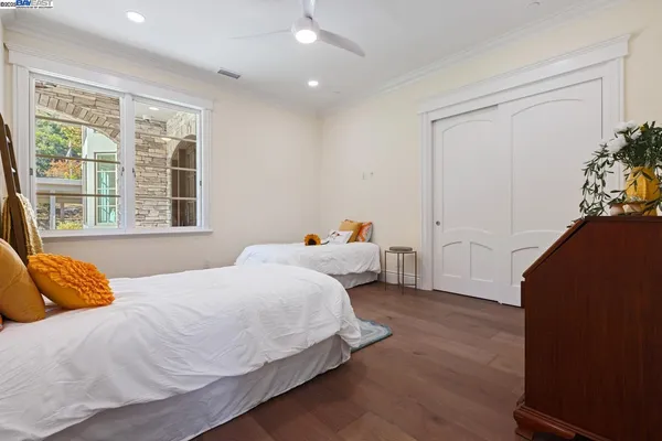 a bedroom with a bed and a window