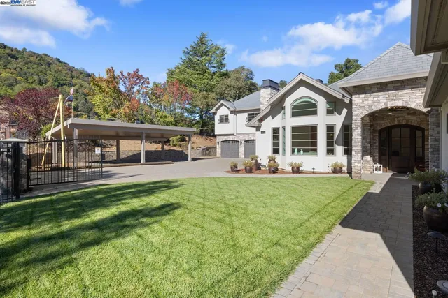 a front view of a house with a yard table and chairs