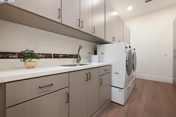 a kitchen with sink cabinets and wooden floor