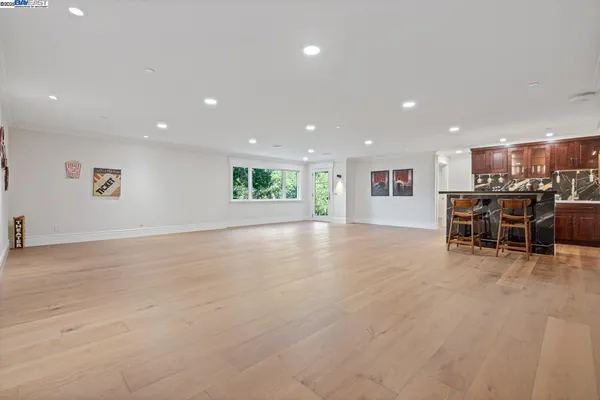 a view of a kitchen with dining room and wooden floor