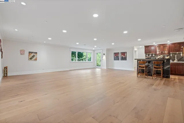 a view of a kitchen with dining room and wooden floor