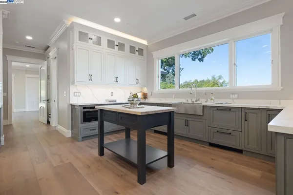 a kitchen with a sink cabinets and window