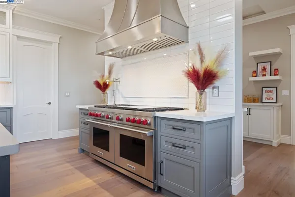 a kitchen with a stove and cabinets