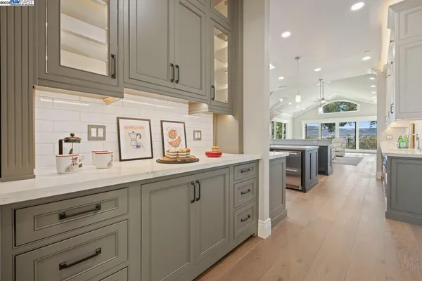 a kitchen with counter top space sink stove and cabinets