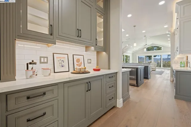 a kitchen with counter top space sink stove and cabinets