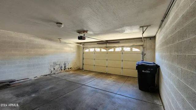 a backyard of a house with large trees and wooden fence
