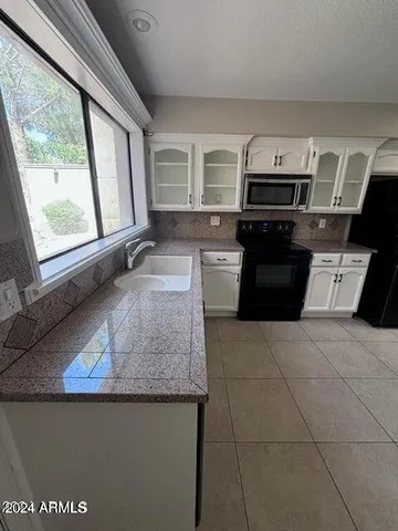 a kitchen with a stove a sink and a microwave