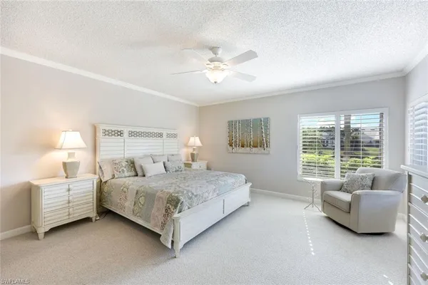 a dining room with furniture a chandelier and wooden floor