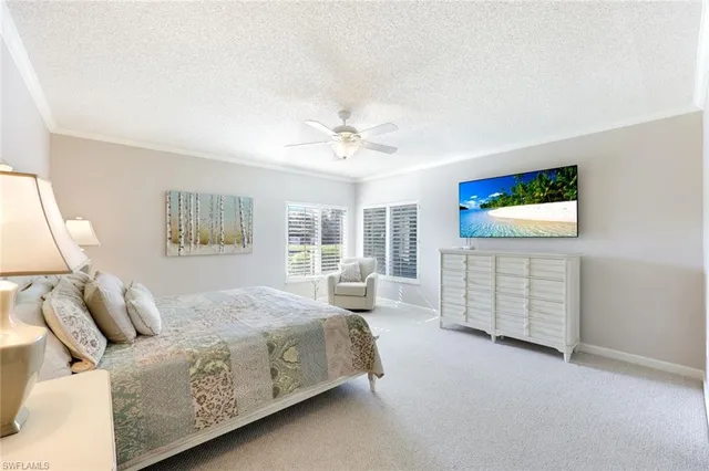 a bedroom with a bed and a couch with exposed radiator