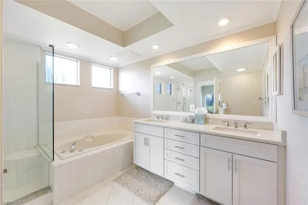 a spacious bedroom with a bed a couch and a window