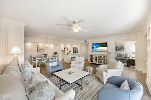 a living room with furniture fireplace and a chandelier