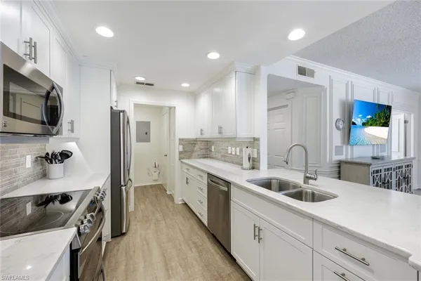 a kitchen with a sink stove and microwave