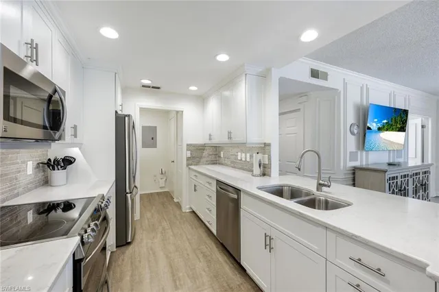 a kitchen with a sink stove and microwave