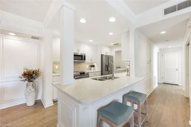 a kitchen with a sink stove and refrigerator