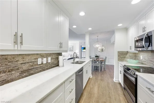a kitchen with refrigerator and a table