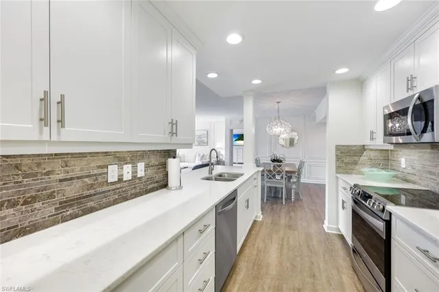 a kitchen with refrigerator and a table