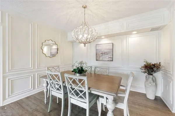 a large kitchen with a large counter top a sink stainless steel appliances and cabinets