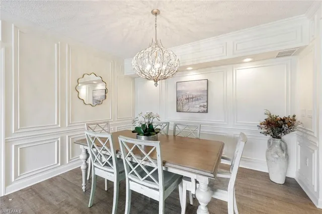 a large kitchen with a large counter top a sink stainless steel appliances and cabinets