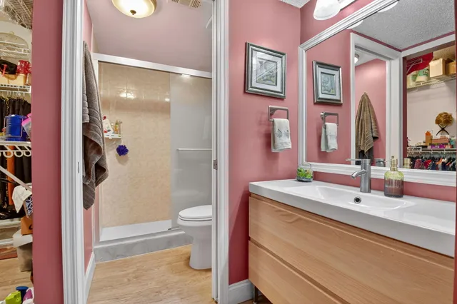 a bathroom with a sink a toilet and shower