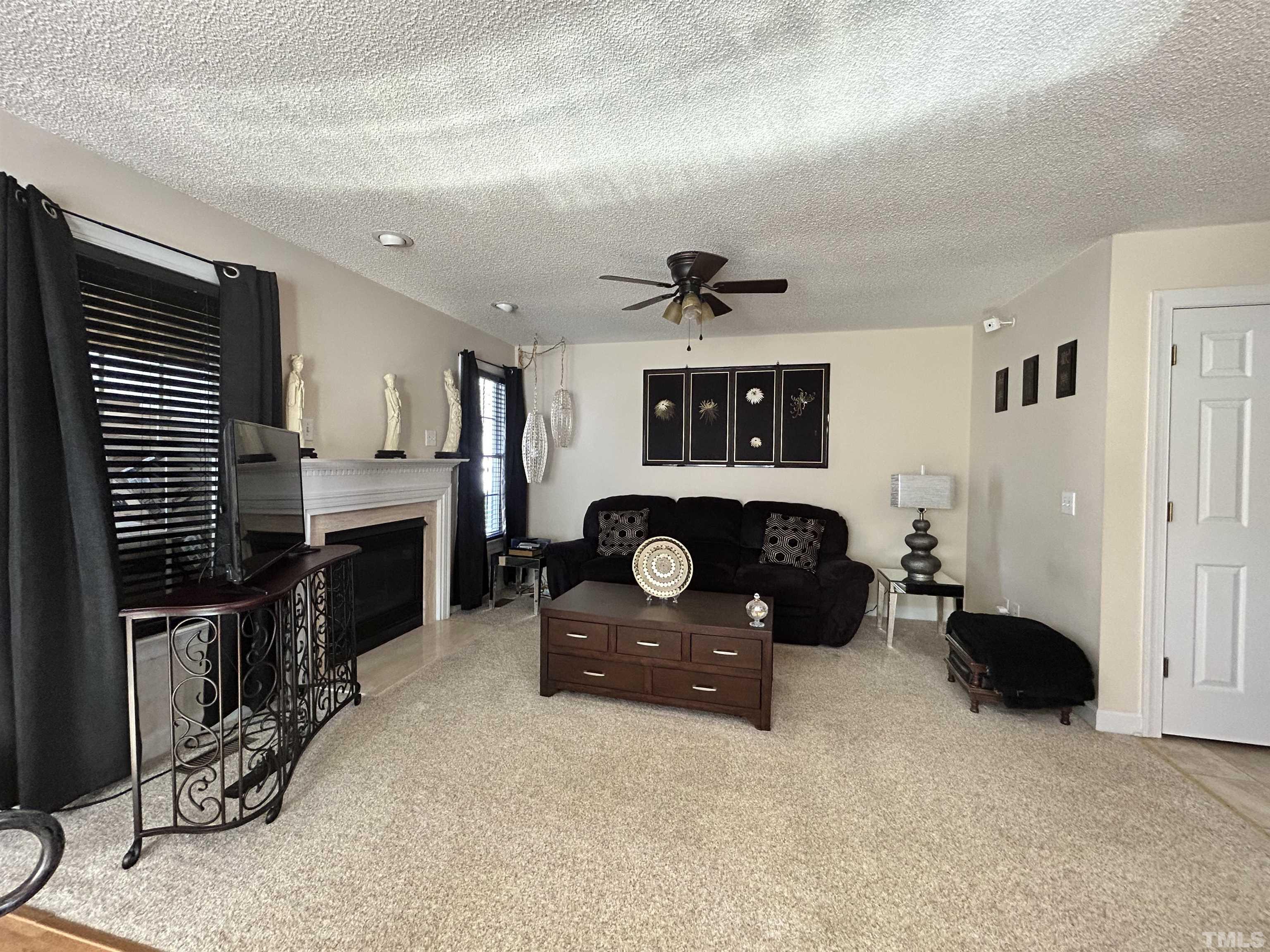 4241 Knightsbridge Way Raleigh, NC 27604 - Photo 4 of 19 a living room with furniture and a flat screen tv