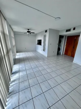 a view of an empty room with a window