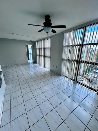 a kitchen with granite countertop a stove a sink and a microwave