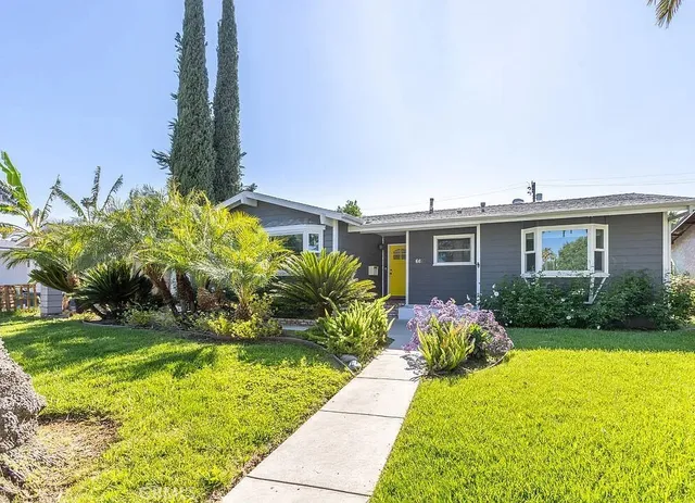 a front view of a house with garden