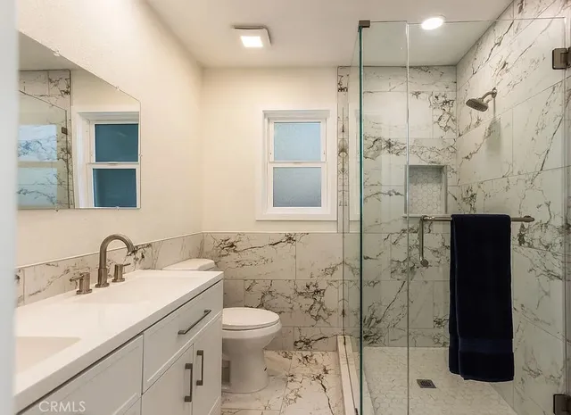 a bathroom with a toilet sink and shower