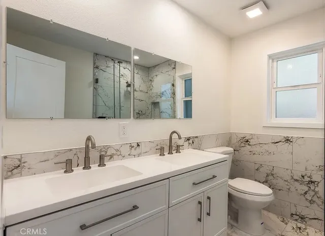 a bathroom with a sink toilet and mirror