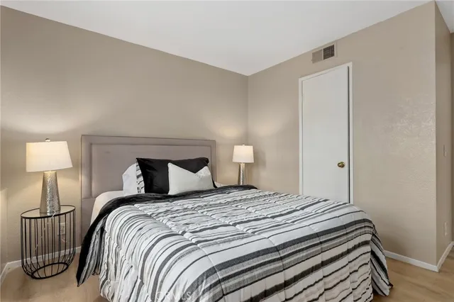 a bedroom with a bed and a lamp