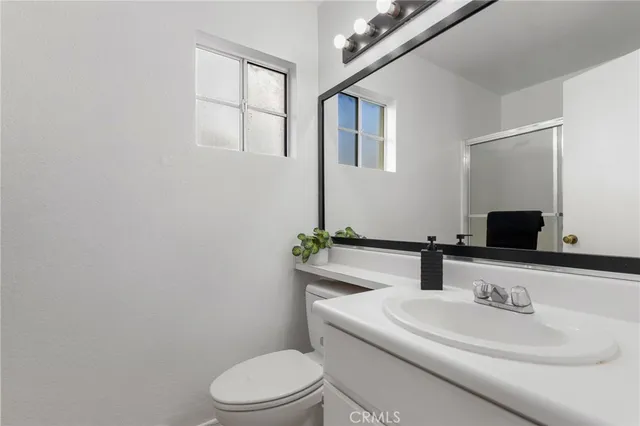 a bathroom with a sink toilet and mirror