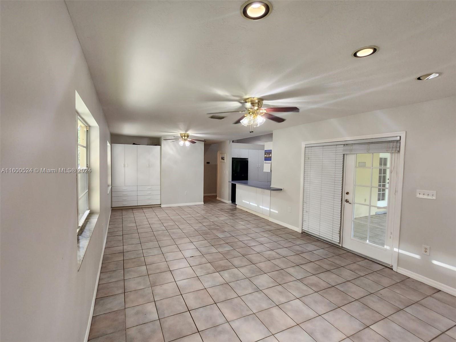 16240 Southwest 286th Street Homestead, FL 33033 - Photo 13 of 14 a view of a livingroom with a chandelier fan and windows