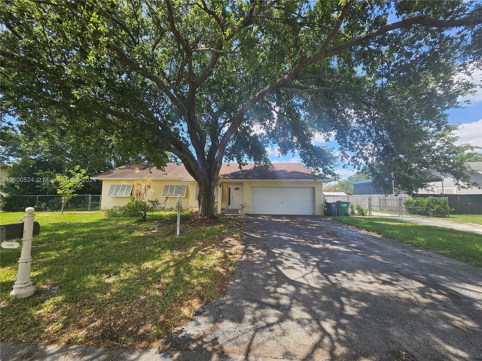 16240 Southwest 286th Street Homestead, FL 33033 - Photo 2 of 14 a house that has tree in front of it