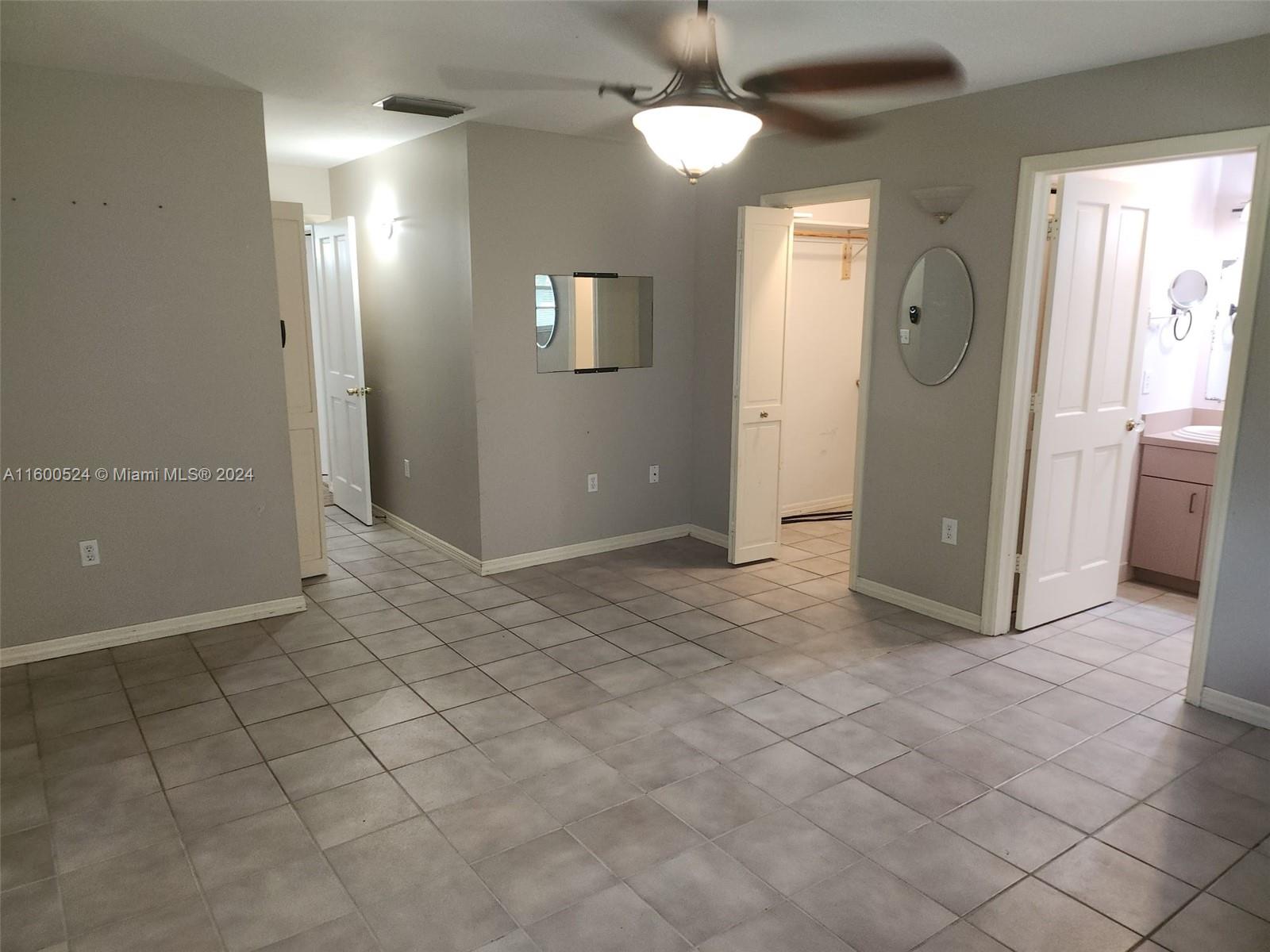 16240 Southwest 286th Street Homestead, FL 33033 - Photo 3 of 14 an empty room with fan and entrance