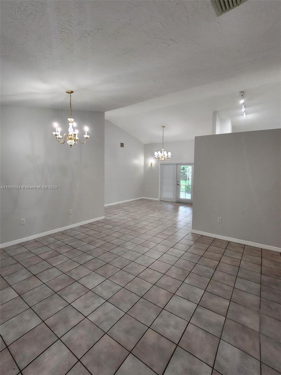 16240 Southwest 286th Street Homestead, FL 33033 - Photo 5 of 14 a view of a livingroom and a chandelier fan