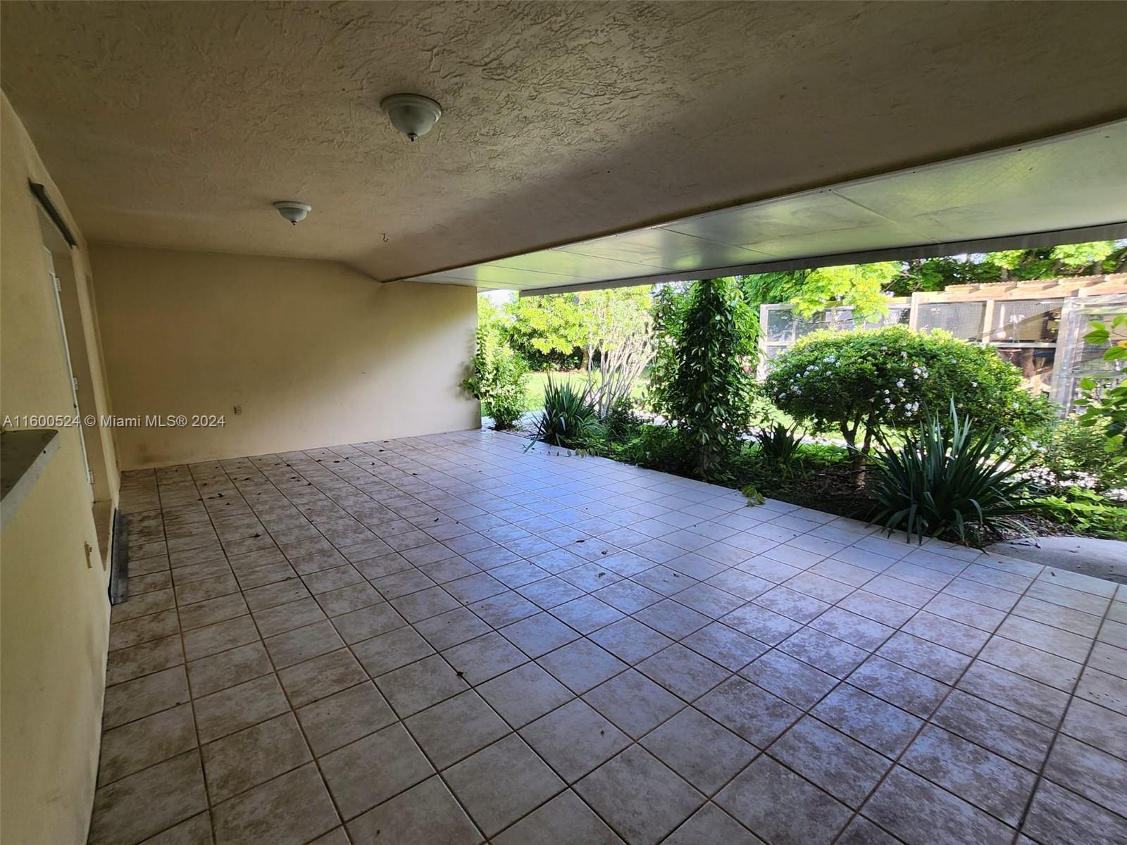 16240 Southwest 286th Street Homestead, FL 33033 - Photo 8 of 14 a view of a garden with plants and a table