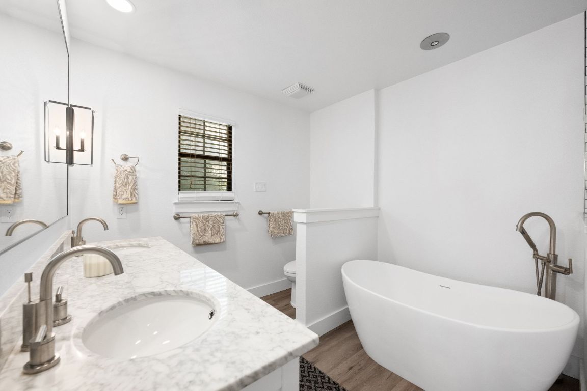 1709 Channel Road Austin, TX 78746 - Photo 17 of 27 a bathroom with a sink and a bathtub