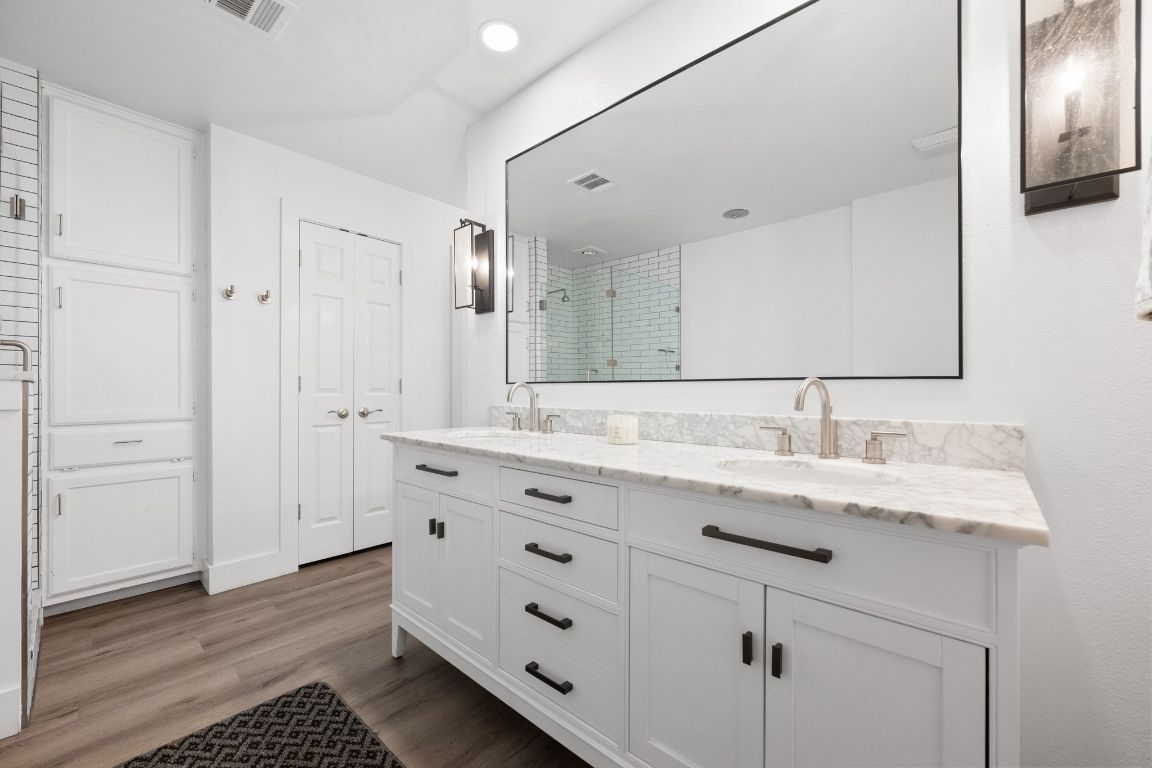 1709 Channel Road Austin, TX 78746 - Photo 18 of 27 a bathroom with a granite countertop sink mirror and double