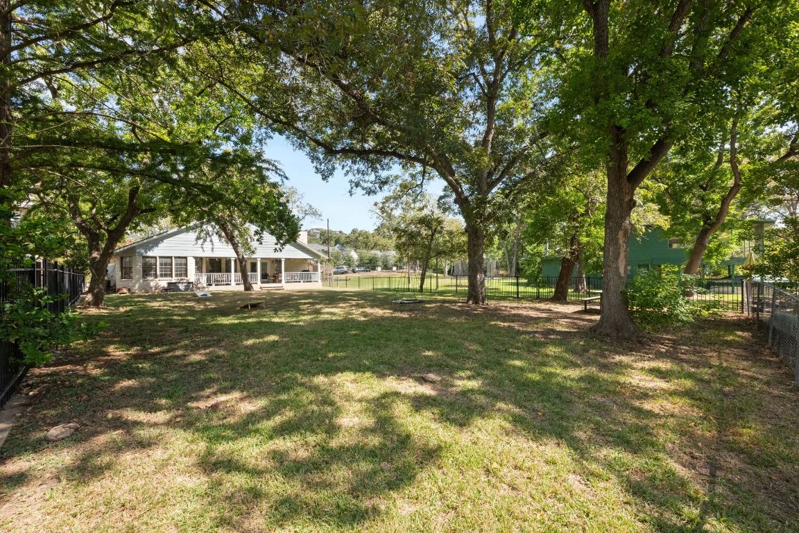1709 Channel Road Austin, TX 78746 - Photo 26 of 27 a view of a house with yard and green space