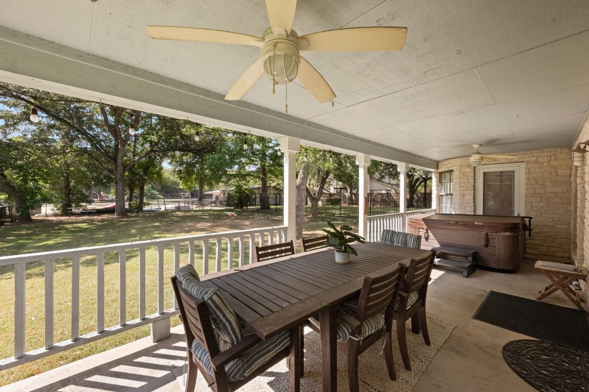 1709 Channel Road Austin, TX 78746 - Photo 3 of 27 a view of a patio with a table chairs and a backyard