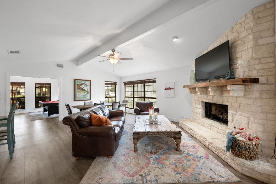 1709 Channel Road Austin, TX 78746 - Photo 7 of 27 a living room with fireplace furniture and a flat screen tv